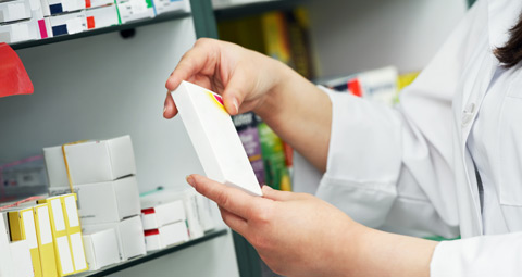 Pharmacist holding a packet of medicine